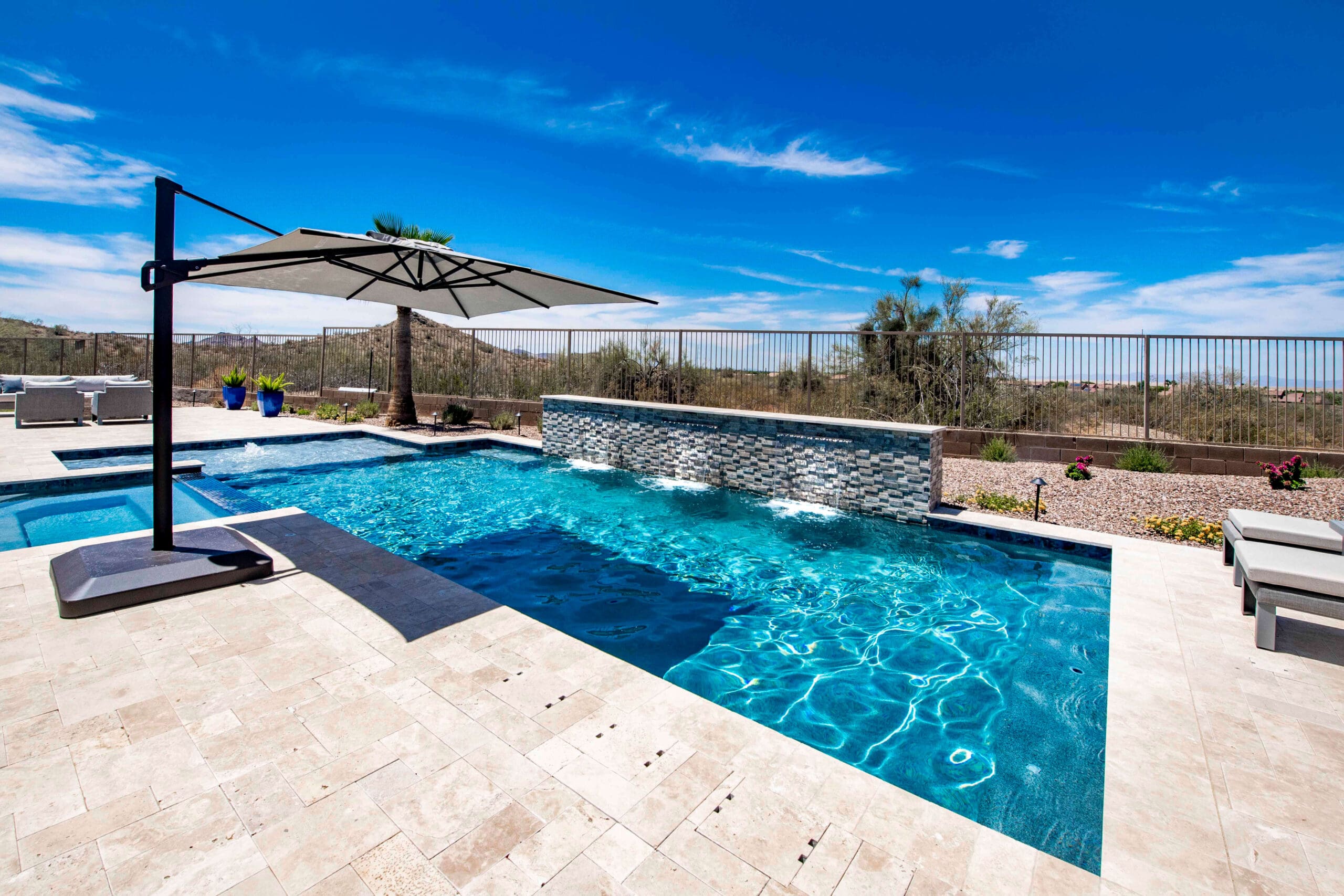 Honed travertine pool deck that stays cooler underfoot in Arizona heat