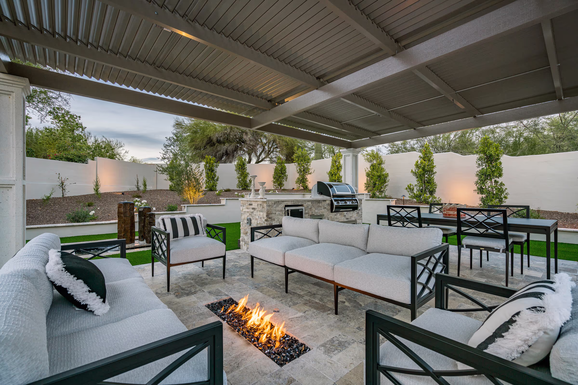 Luxury spec home Paradise Valley backyard with covered patio, pool, and landscape lighting